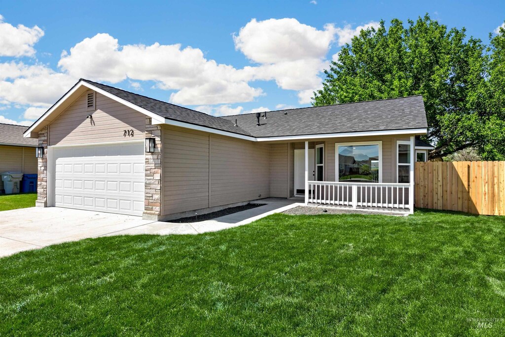 712 Teton Dr, Nampa, ID 83686 - ranch-style home featuring a garage, covered porch, driveway, and roof with shingles