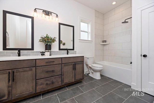 full bathroom featuring toilet, vanity, and tiled shower / bath combo