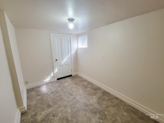1603 11th Ave, Lewiston, ID 83501 - spare room with baseboards, concrete flooring, and a textured ceiling