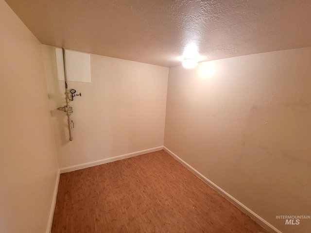 1603 11th Ave, Lewiston, ID 83501 - empty room with light wood finished floors, a textured ceiling, and baseboards