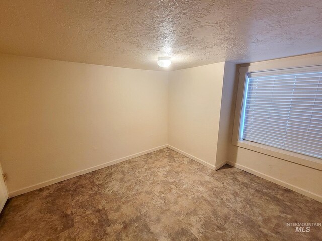 1603 11th Ave, Lewiston, ID 83501 - spare room with a textured ceiling and baseboards
