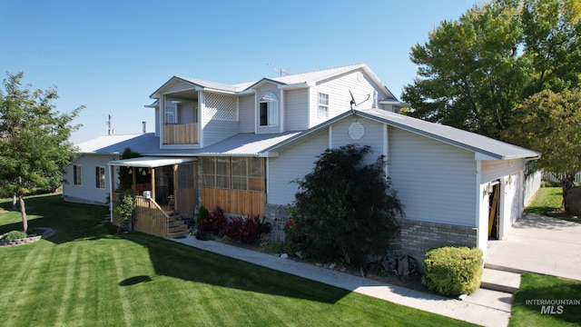 view of front of home with a garage and a front lawn