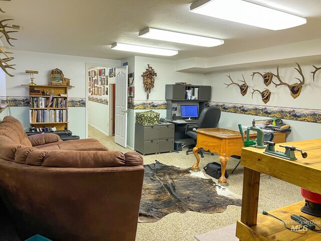 office space with a textured ceiling and light colored carpet