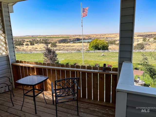 wooden deck with a rural view