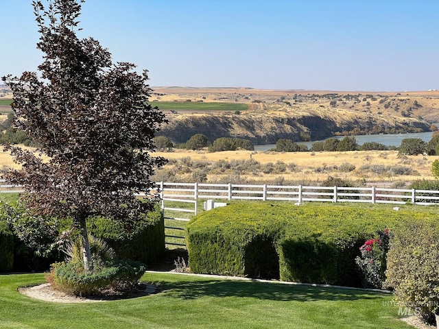 view of yard featuring a rural view and a water view