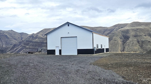 view of outdoor structure featuring a mountain view and a garage