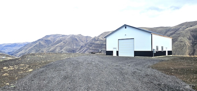 view of outbuilding featuring a mountain view and a garage