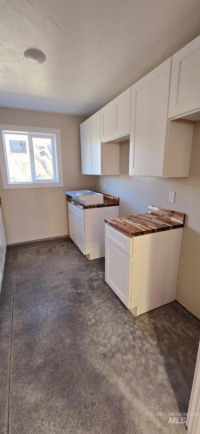 kitchen with dark carpet and white cabinets