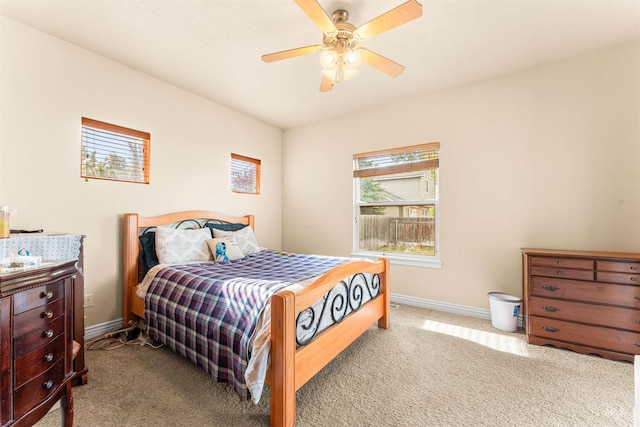 carpeted bedroom with baseboards and a ceiling fan