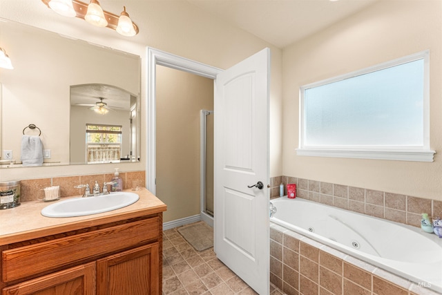 full bath with ceiling fan, a whirlpool tub, vanity, and a stall shower