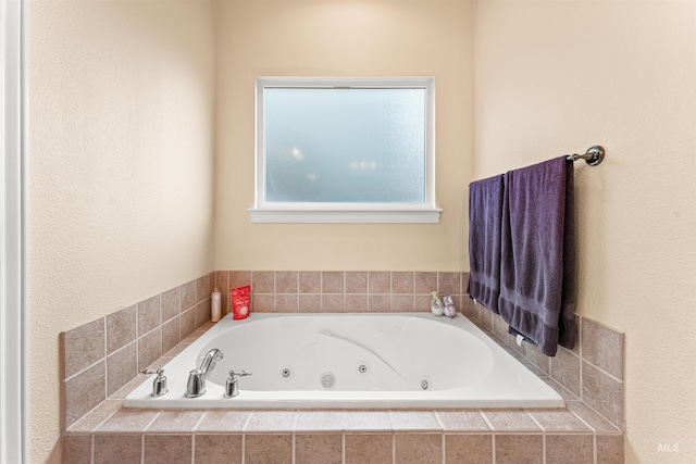 bathroom featuring a tub with jets
