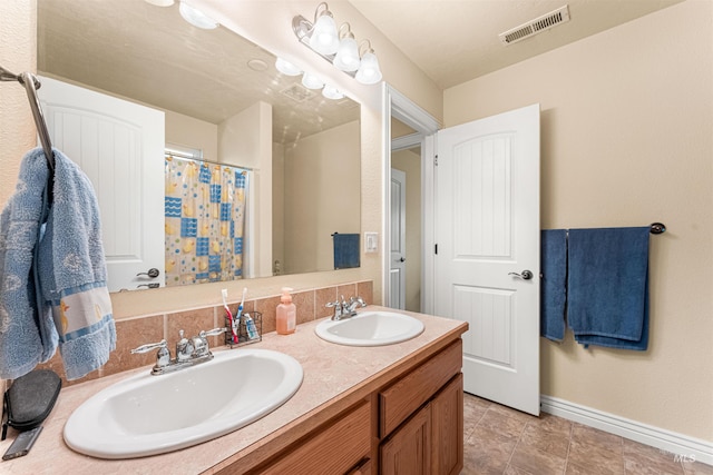 full bathroom with baseboards, double vanity, and a shower with curtain