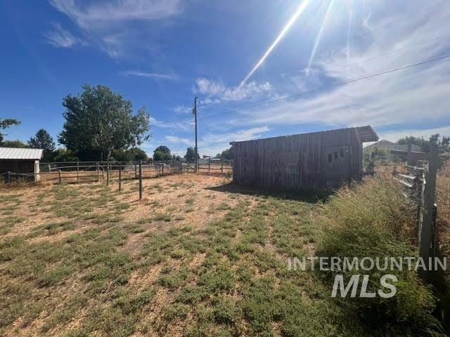 view of yard featuring an outbuilding and a rural view