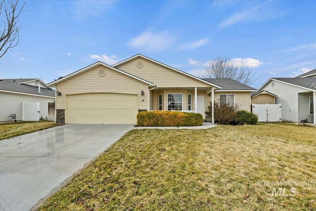 ranch-style house with fence, concrete driveway, a front yard, a garage, and a gate