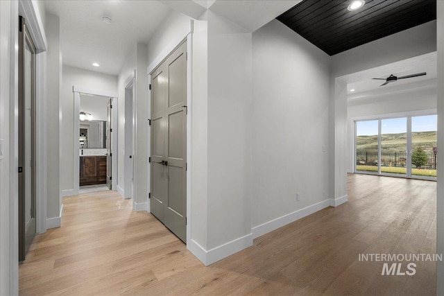 hall with light hardwood / wood-style flooring