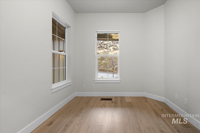 spare room with light hardwood / wood-style floors