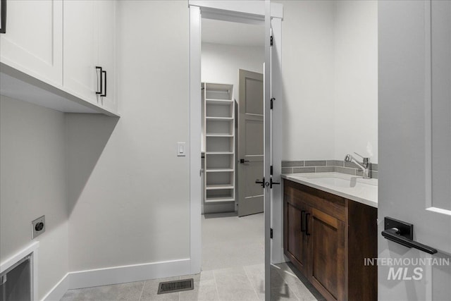 bathroom with tile patterned flooring and vanity