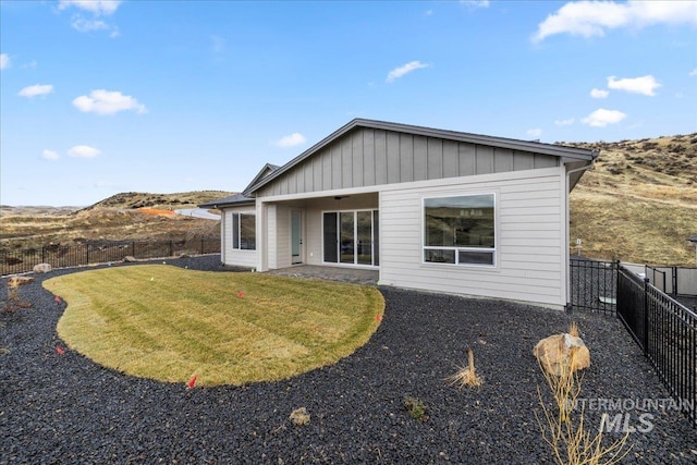 rear view of property featuring a yard