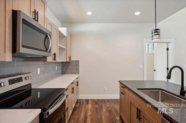 701 N 2nd Ave, Hailey, ID 83333 - kitchen with dark wood-style flooring, a sink, stainless steel appliances, baseboards, and backsplash