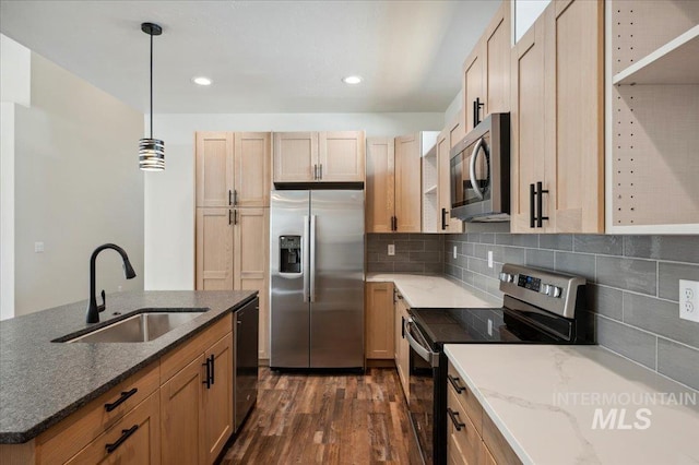 701 N 2nd Ave, Hailey, ID 83333 - kitchen featuring dark wood-style floors, a sink, dark stone countertops, appliances with stainless steel finishes, and backsplash