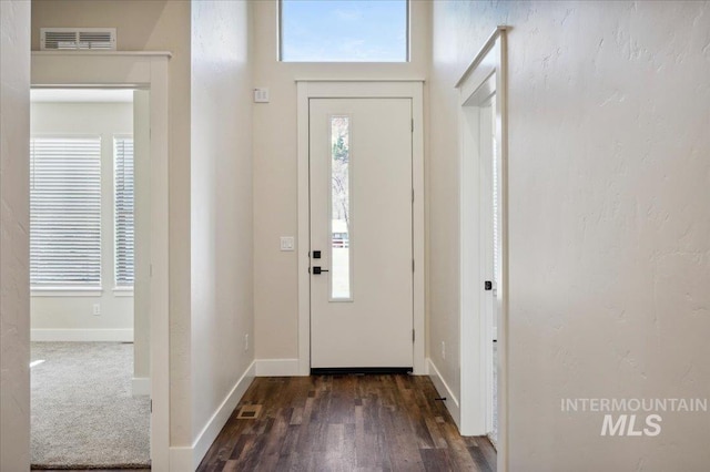 701 N 2nd Ave, Hailey, ID 83333 - foyer entrance with dark wood-style flooring, baseboards, visible vents, and a healthy amount of sunlight