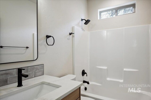 701 N 2nd Ave, Hailey, ID 83333 - full bathroom featuring vanity, shower / bathtub combination, toilet, and tasteful backsplash