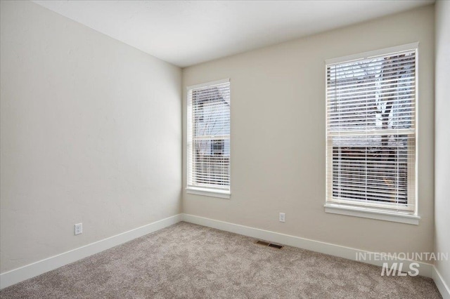 701 N 2nd Ave, Hailey, ID 83333 - unfurnished room with light colored carpet, baseboards, and visible vents