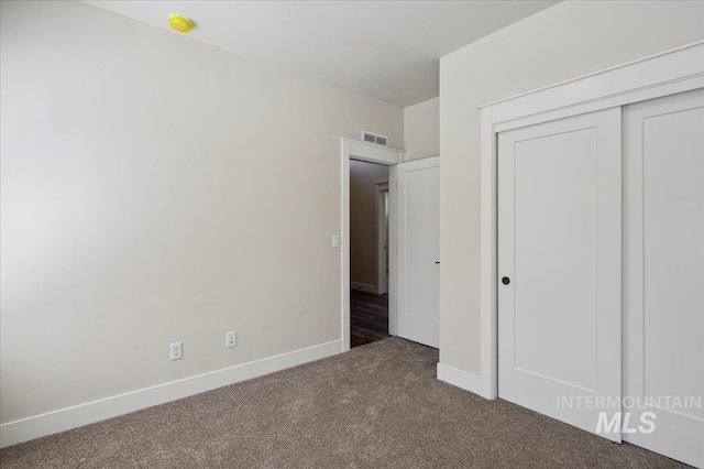 701 N 2nd Ave, Hailey, ID 83333 - unfurnished bedroom featuring baseboards, carpet, a closet, and visible vents