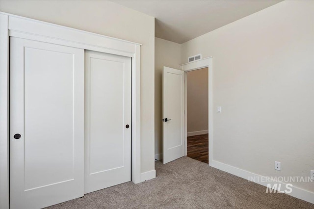 701 N 2nd Ave, Hailey, ID 83333 - unfurnished bedroom featuring a closet, baseboards, light colored carpet, and visible vents