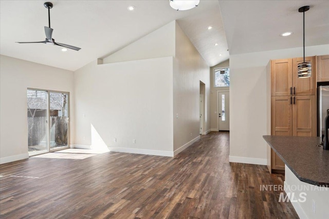701 N 2nd Ave, Hailey, ID 83333 - unfurnished living room with dark wood-style flooring, ceiling fan, and a wealth of natural light