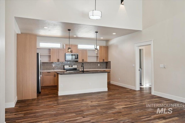 701 N 2nd Ave, Hailey, ID 83333 - kitchen with dark wood-type flooring, open shelves, dark countertops, and stainless steel appliances