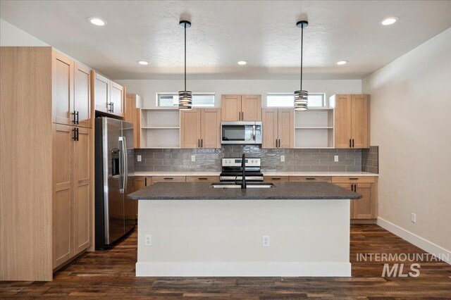 701 N 2nd Ave, Hailey, ID 83333 - kitchen with light brown cabinetry, appliances with stainless steel finishes, open shelves, and an island with sink