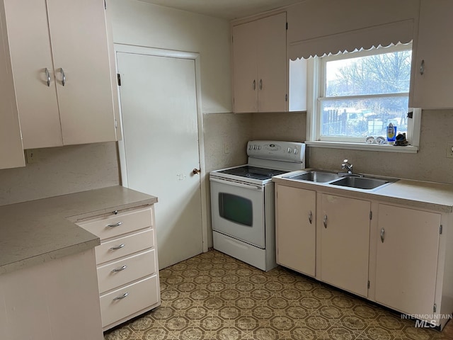 kitchen featuring sink, backsplash, white cabinetry, and electric stove