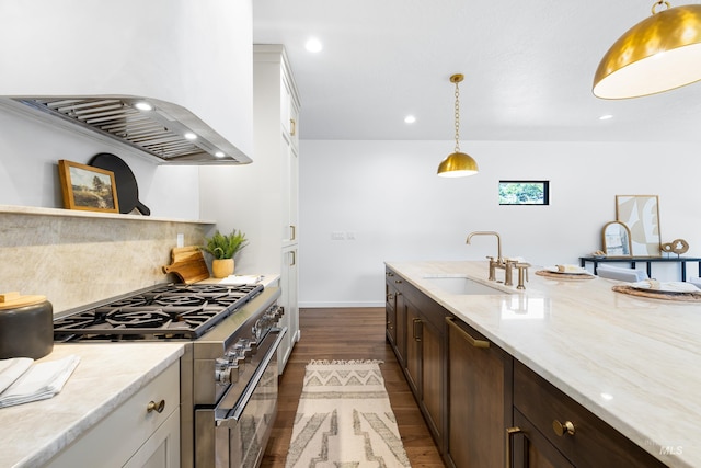 2206 N 20th, Boise, ID 83702 - kitchen with high end stainless steel range, wall chimney exhaust hood, dark wood finished floors, backsplash, and pendant lighting