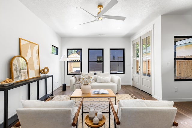 2206 N 20th, Boise, ID 83702 - living room featuring healthy amount of natural light, wood finished floors, ceiling fan, recessed lighting, and a textured ceiling