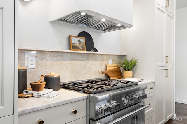 2206 N 20th, Boise, ID 83702 - kitchen with high end stainless steel range oven, range hood, backsplash, white cabinetry, and dark wood finished floors