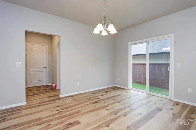 10224 W Altair, Star, ID 83669 - empty room with light wood finished floors and a chandelier