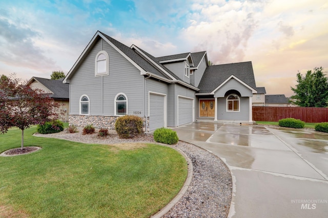 10224 W Altair, Star, ID 83669 - view of front facade featuring concrete driveway, roof with shingles, stone siding, and an attached garage