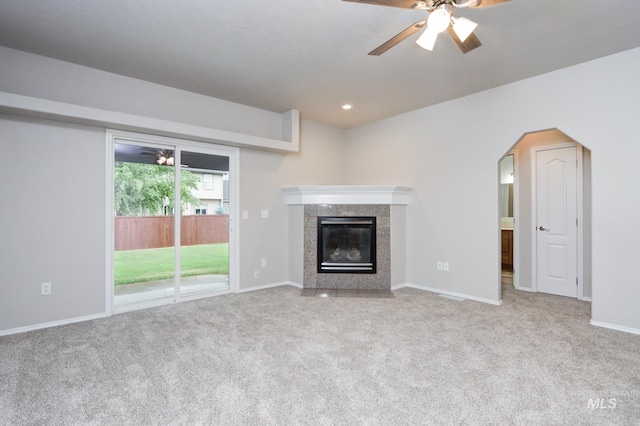 10224 W Altair, Star, ID 83669 - unfurnished living room featuring ceiling fan, carpet floors, a premium fireplace, and arched walkways