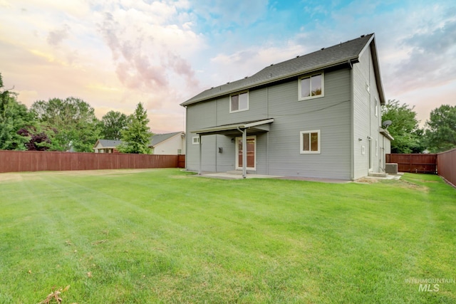 10224 W Altair, Star, ID 83669 - back of house at dusk with a patio and a fenced backyard