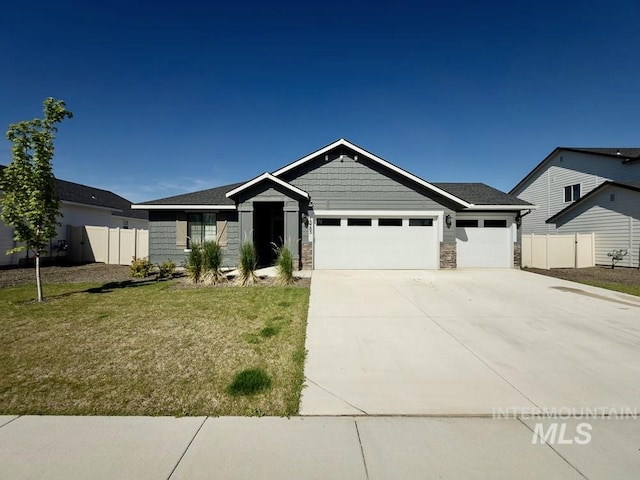 13743 S Sonata Way, Nampa, ID 83651 - view of front of house featuring a garage, concrete driveway, and stone siding