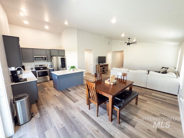 13743 S Sonata Way, Nampa, ID 83651 - dining space with a ceiling fan, high vaulted ceiling, light wood finished floors, and recessed lighting
