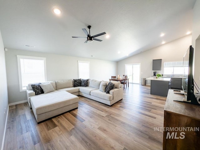 13743 S Sonata Way, Nampa, ID 83651 - living area with lofted ceiling, a ceiling fan, wood finished floors, and recessed lighting