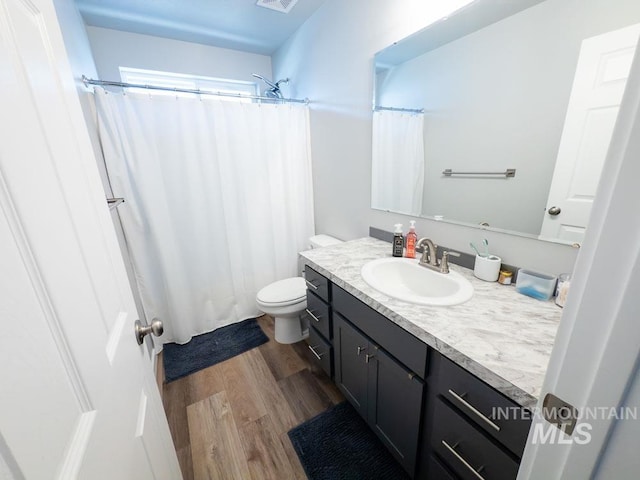 13743 S Sonata Way, Nampa, ID 83651 - bathroom with vanity, wood finished floors, and toilet
