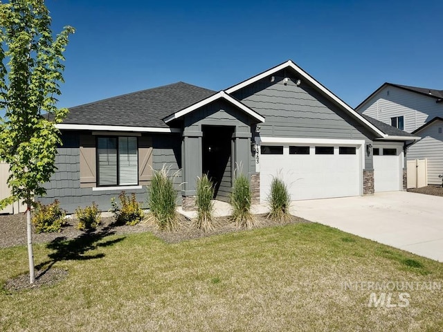 13743 S Sonata Way, Nampa, ID 83651 - view of front of home featuring an attached garage, concrete driveway, a front yard, and a shingled roof