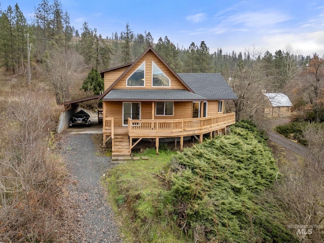 back of house featuring a carport and a wooden deck