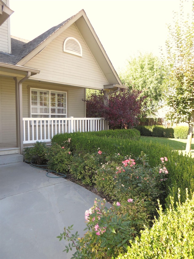 view of side of home with a porch