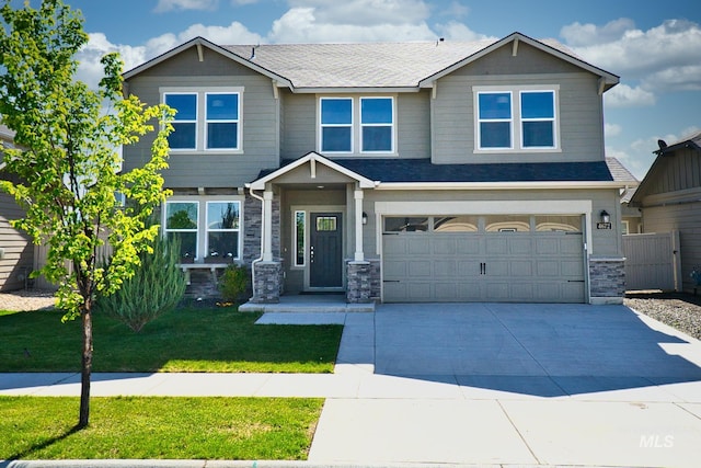 4672 N Patimos Ave, Meridian, ID 83646 - craftsman inspired home featuring driveway, stone siding, a front lawn, a garage, and roof with shingles