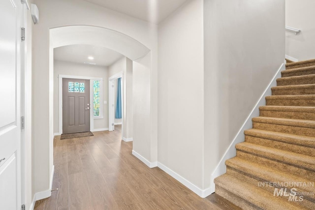 4672 N Patimos Ave, Meridian, ID 83646 - foyer entrance with arched walkways, wood finished floors, stairs, and baseboards