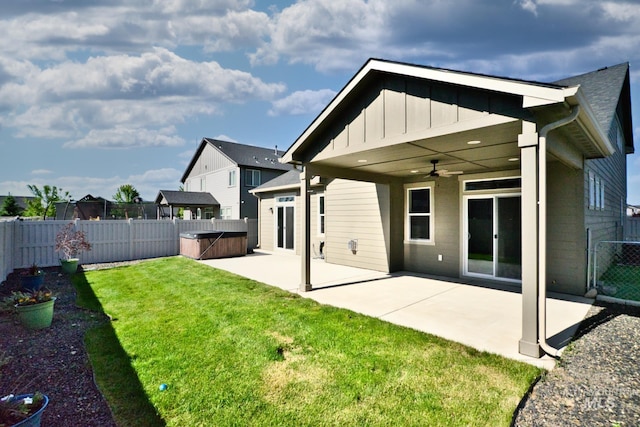 4672 N Patimos Ave, Meridian, ID 83646 - rear view of property featuring board and batten siding, ceiling fan, a patio, and a hot tub
